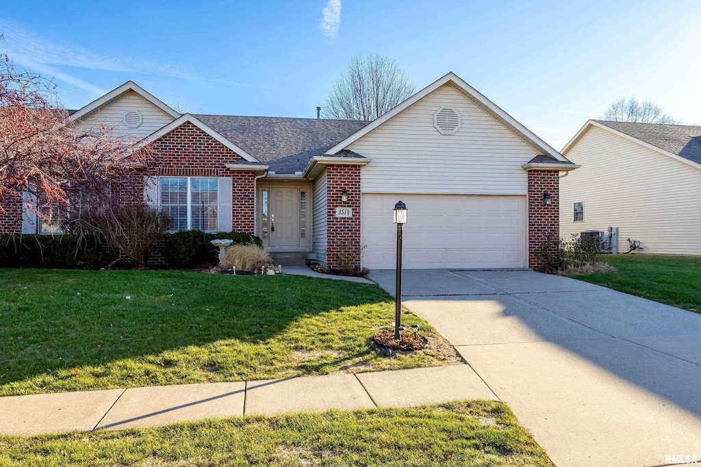 ranch-style home featuring a garage and a front lawn