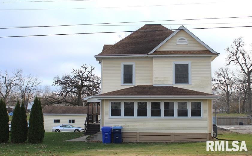 view of side of home with a yard