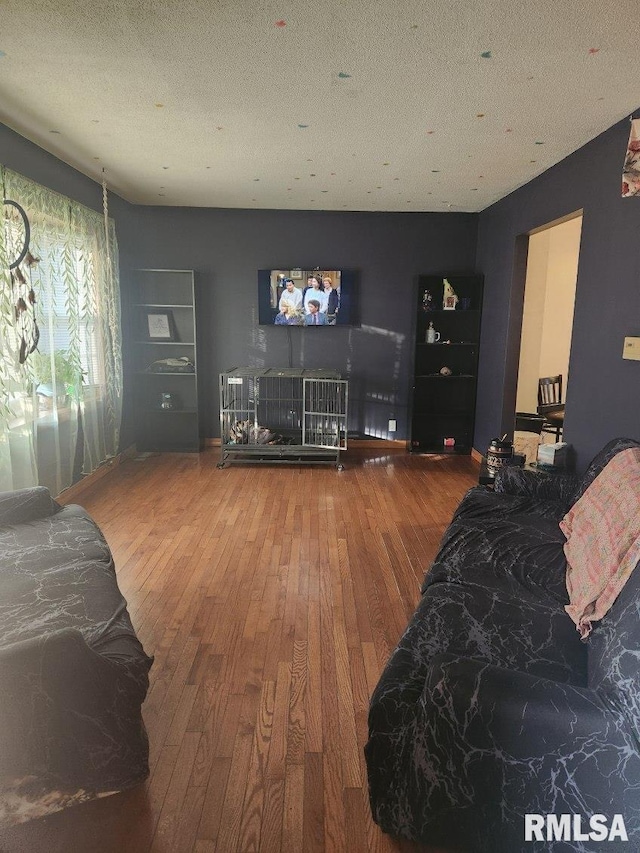 bedroom with wood-type flooring and a textured ceiling