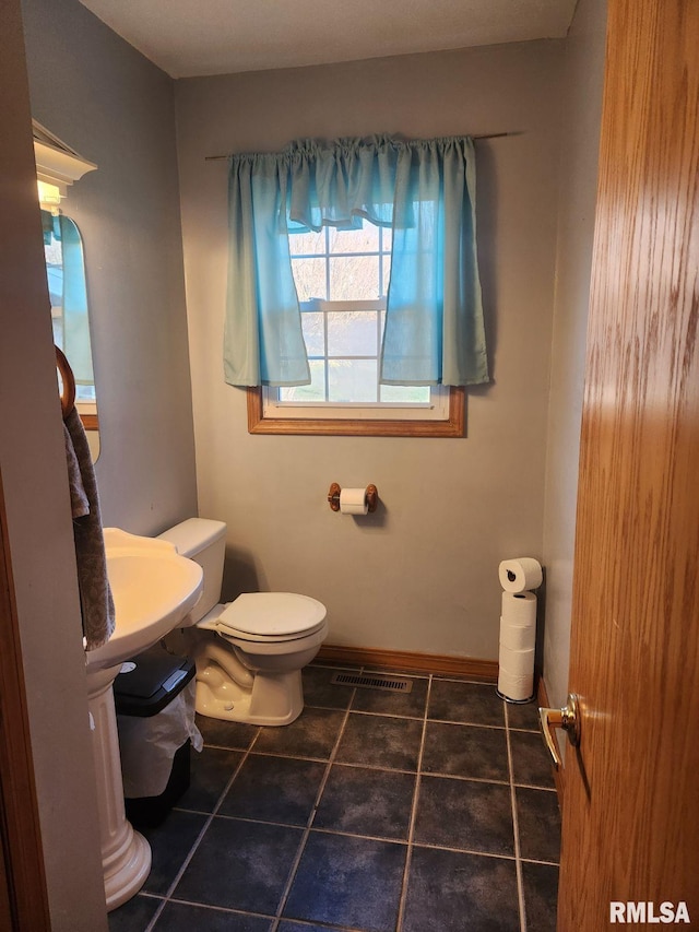 bathroom with tile patterned floors and toilet