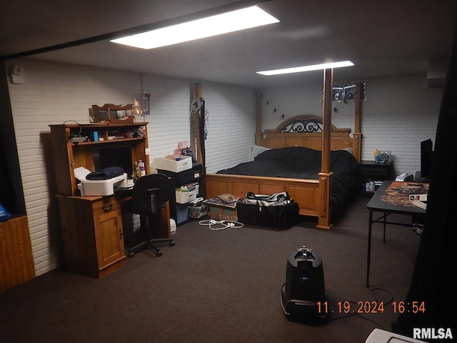 bedroom featuring brick wall