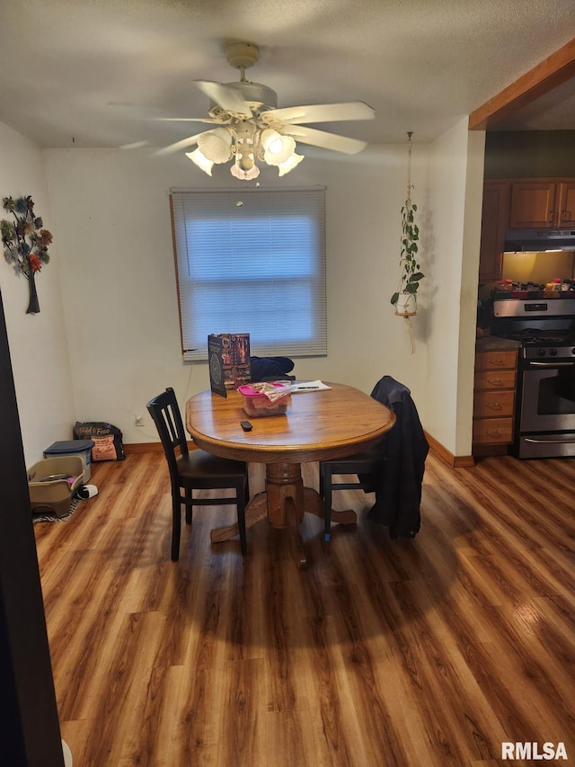 dining area featuring ceiling fan and dark hardwood / wood-style flooring