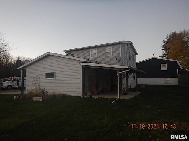 back house at dusk with a yard