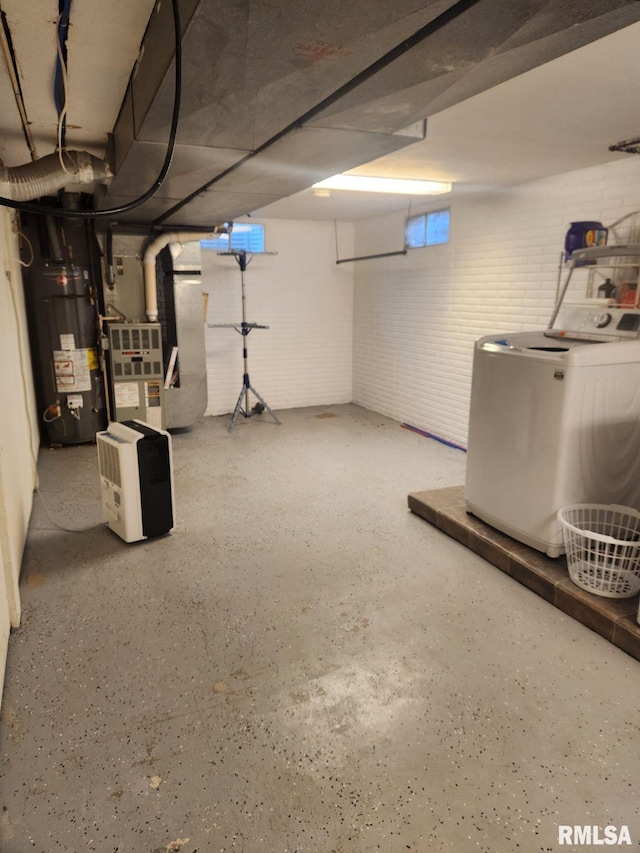 basement with heating unit, washer / dryer, and water heater