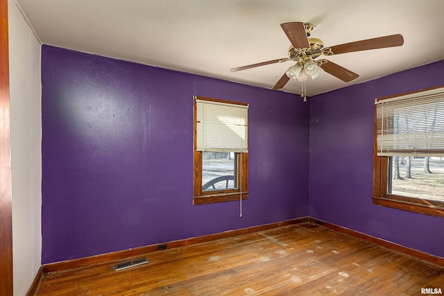 unfurnished room with hardwood / wood-style floors and ceiling fan