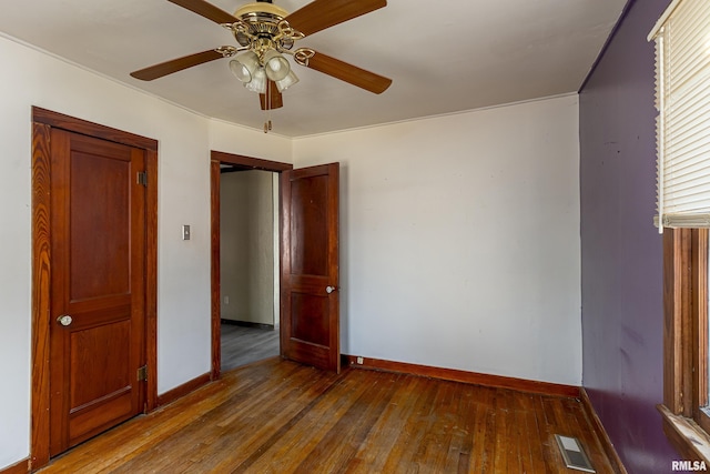 unfurnished bedroom with wood-type flooring, ceiling fan, and a closet