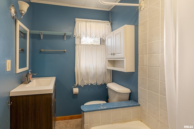 bathroom featuring vanity, ornamental molding, and toilet