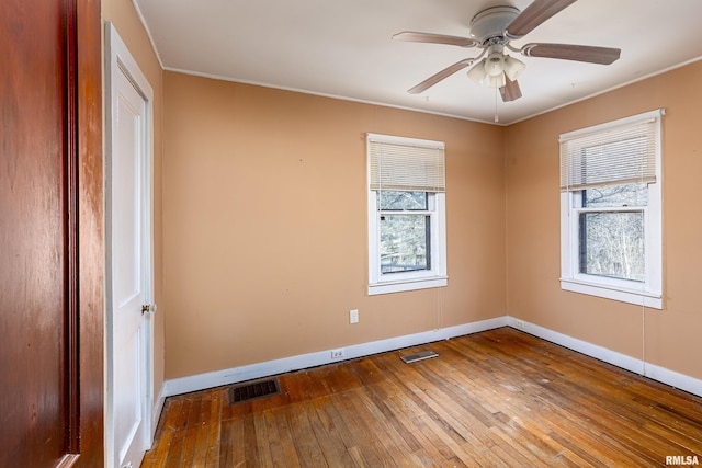 spare room with hardwood / wood-style flooring and ceiling fan