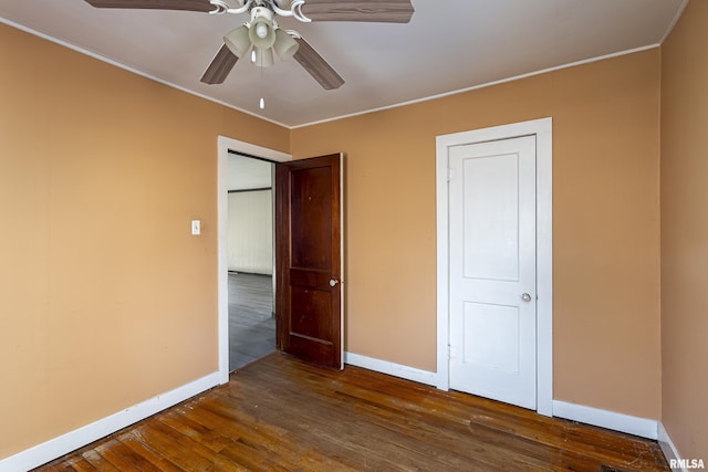 unfurnished bedroom with dark hardwood / wood-style flooring and ceiling fan