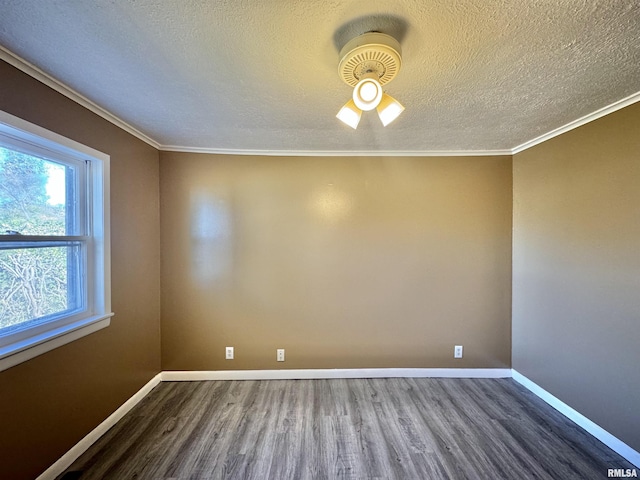 empty room with a textured ceiling, crown molding, baseboards, and wood finished floors