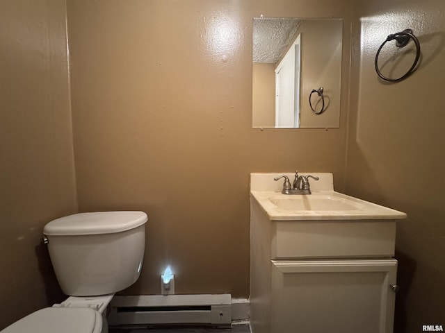 bathroom featuring toilet, vanity, and a baseboard heating unit