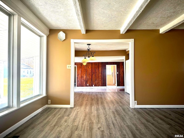 interior space with beamed ceiling, a textured ceiling, dark hardwood / wood-style flooring, and a notable chandelier