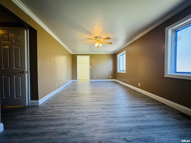 unfurnished room featuring crown molding, wood finished floors, baseboards, and ceiling fan