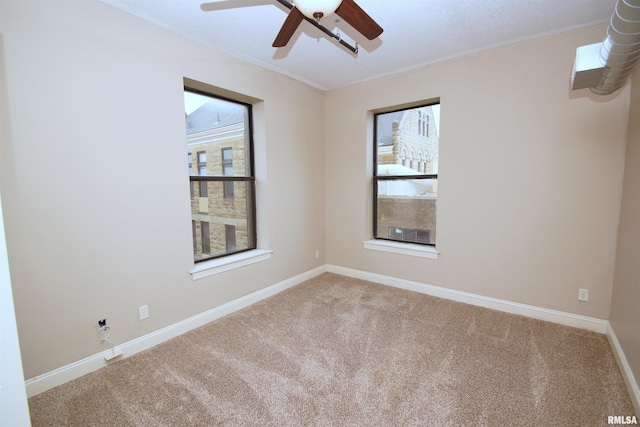 empty room featuring carpet flooring and ceiling fan