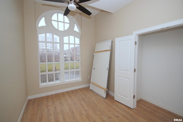 unfurnished bedroom with ceiling fan and light hardwood / wood-style flooring