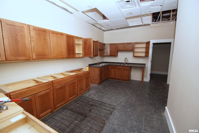 kitchen featuring a paneled ceiling and sink