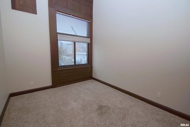 unfurnished room featuring light carpet