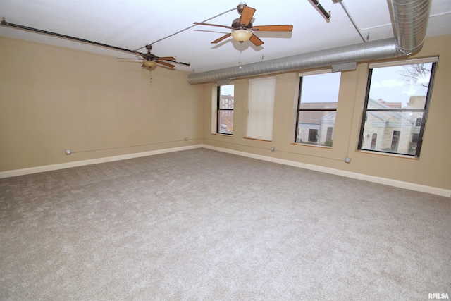 empty room featuring carpet floors and ceiling fan