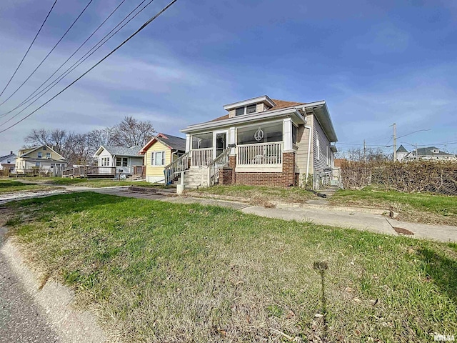 view of front of house with a porch and a front yard