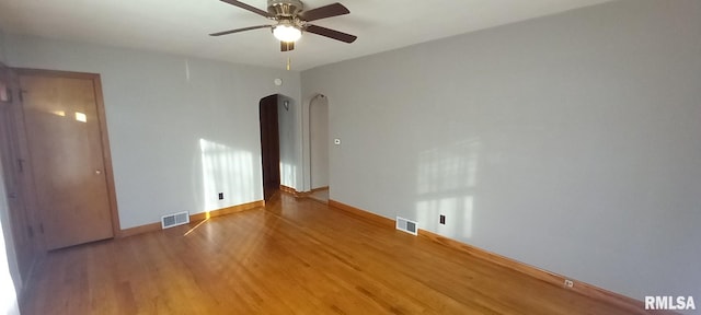 spare room with hardwood / wood-style floors and ceiling fan