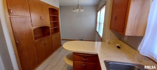 interior space featuring sink and a chandelier