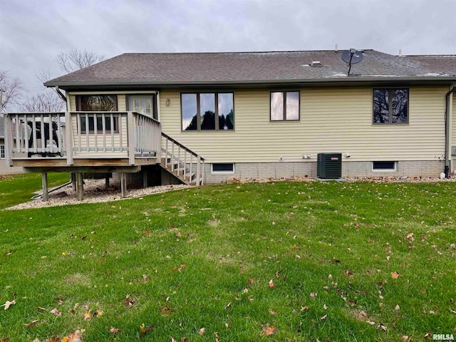 rear view of property featuring a wooden deck, a yard, and central AC unit