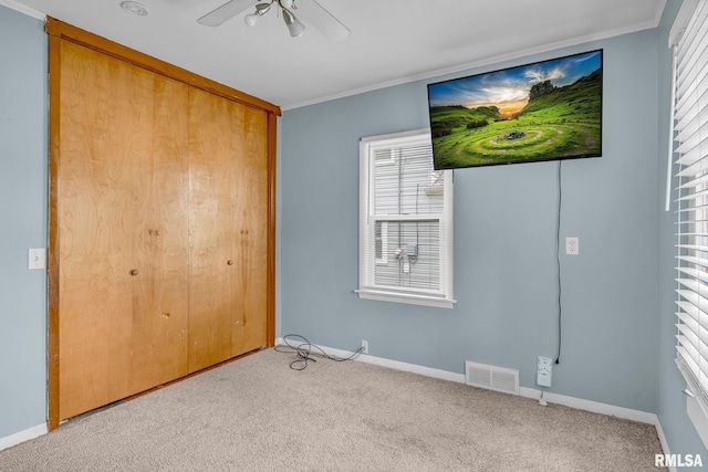 unfurnished bedroom with a closet, ceiling fan, and ornamental molding