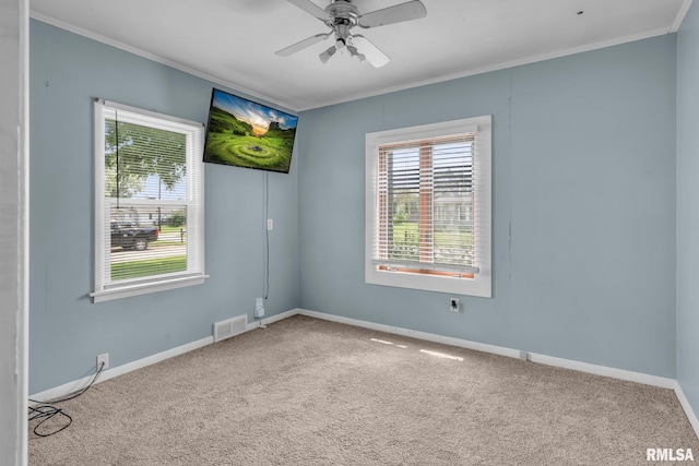 carpeted empty room with ceiling fan and crown molding