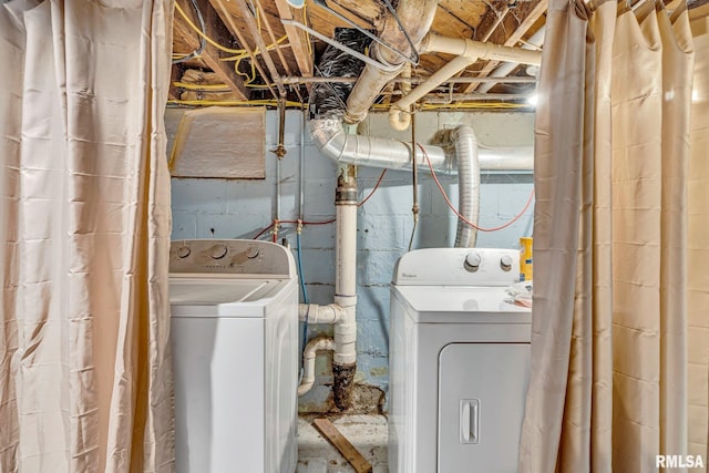 clothes washing area featuring washer and dryer