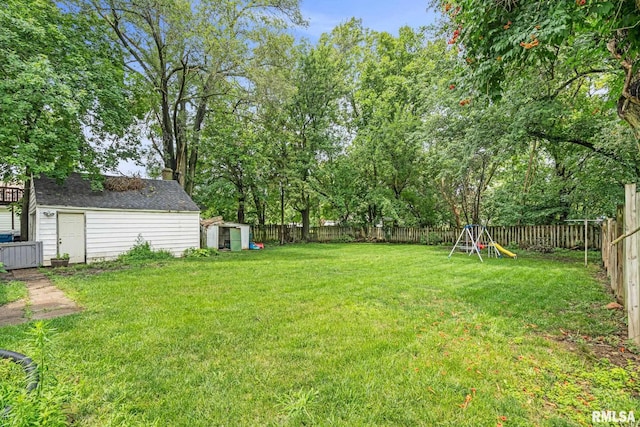 view of yard featuring a playground and a storage shed