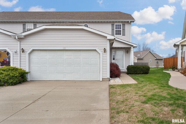 front of property with a front yard and a garage