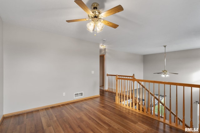 empty room with ceiling fan and hardwood / wood-style floors