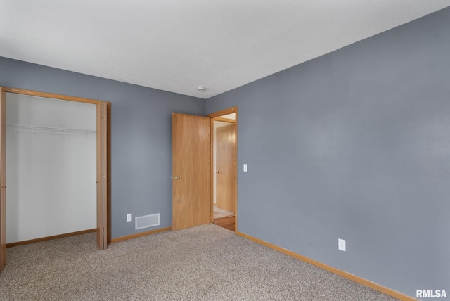 unfurnished bedroom featuring carpet floors and a closet