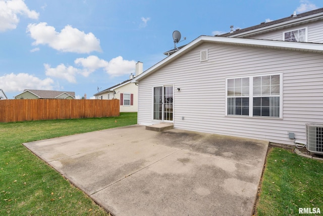 rear view of house featuring central AC unit, a patio, and a lawn