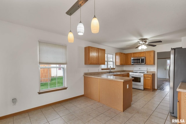 kitchen featuring pendant lighting, plenty of natural light, sink, and stainless steel appliances