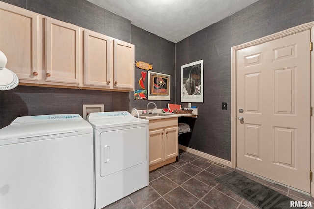 clothes washing area featuring cabinets, separate washer and dryer, dark tile patterned flooring, and sink