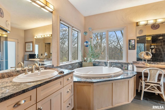 bathroom featuring tile patterned floors, vanity, and a tub