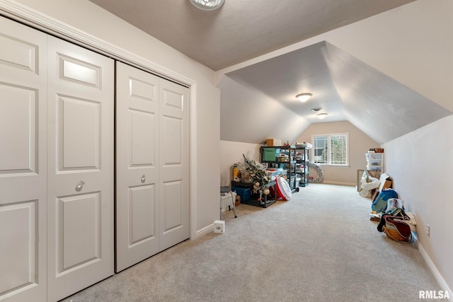 game room featuring light carpet and vaulted ceiling