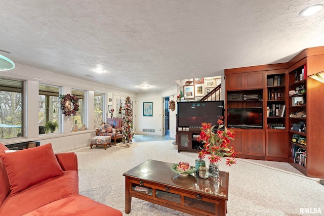 carpeted living room with a textured ceiling