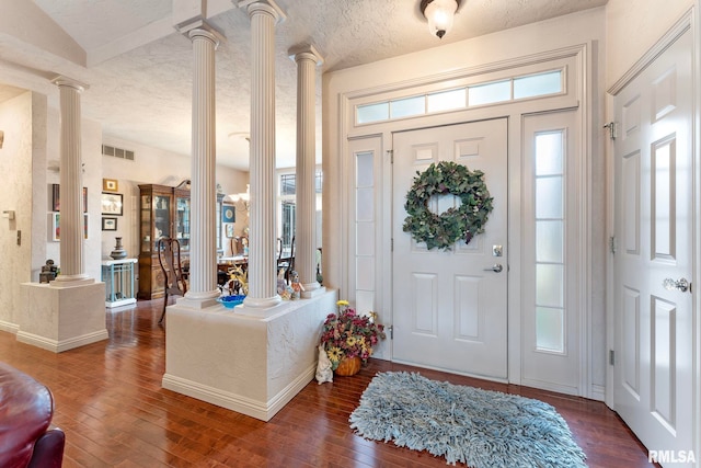 foyer with dark hardwood / wood-style flooring and decorative columns