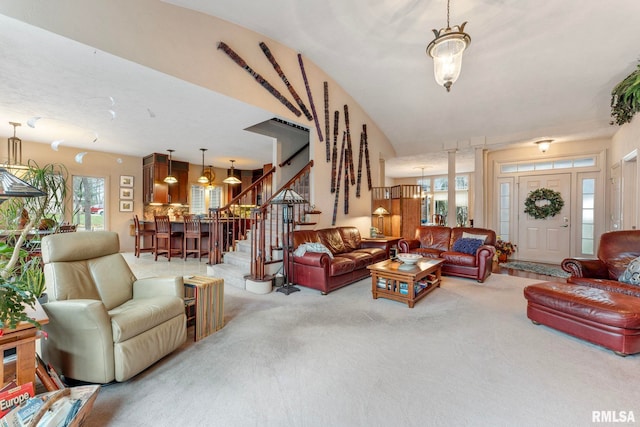 living room featuring carpet flooring and an inviting chandelier