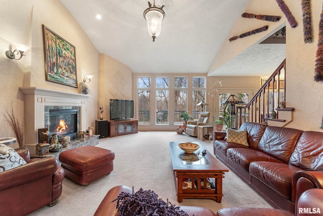 living room featuring a high end fireplace, carpet flooring, and lofted ceiling