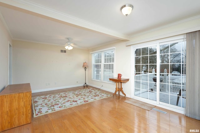 unfurnished room with crown molding, hardwood / wood-style floors, and ceiling fan