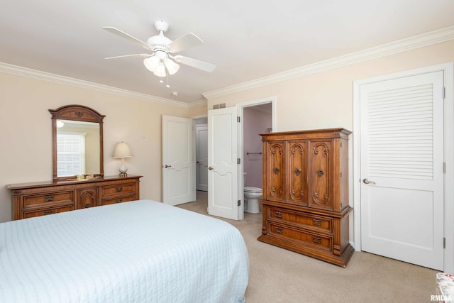 carpeted bedroom featuring ensuite bathroom, ceiling fan, and ornamental molding