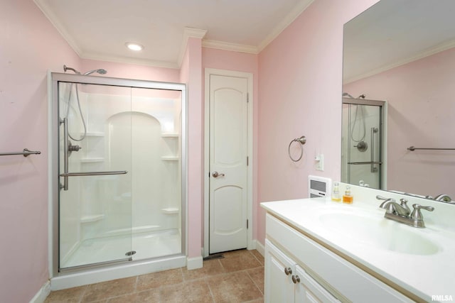 bathroom featuring vanity, tile patterned floors, a shower with door, and crown molding