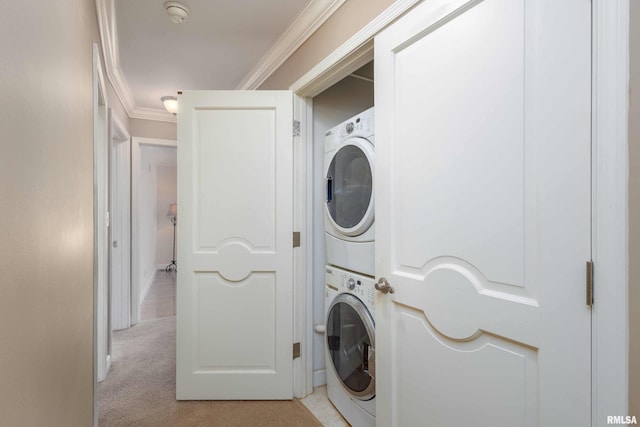 laundry room with ornamental molding, light colored carpet, and stacked washer and clothes dryer