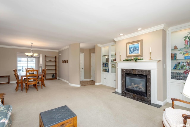 carpeted living room with a notable chandelier, crown molding, and a high end fireplace