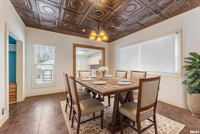 tiled dining room featuring a chandelier