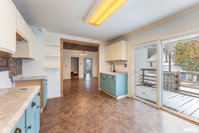 kitchen featuring tile patterned floors, sink, and ornamental molding