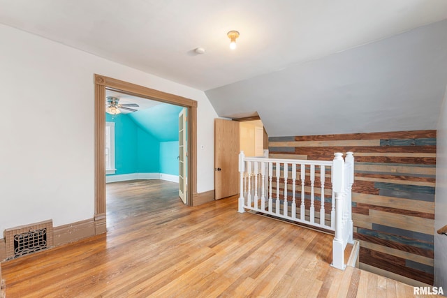 additional living space featuring hardwood / wood-style floors, ceiling fan, and lofted ceiling